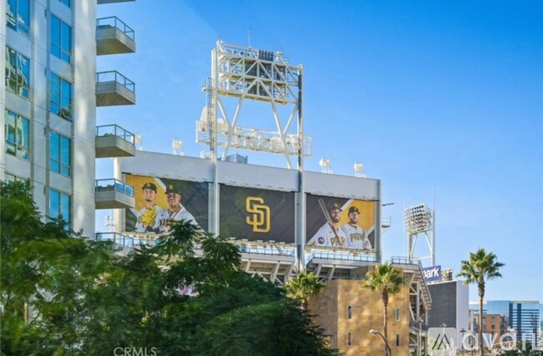 A large billboard with a baseball player on it is displayed on a building.