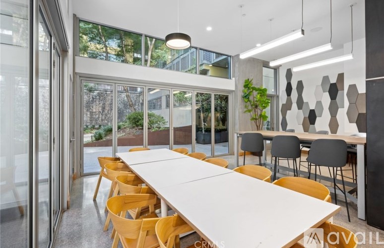 A conference room with a long table and chairs.