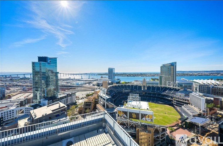A sunny day at a baseball stadium with a clear blue sky.