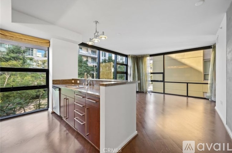 A modern kitchen with white cabinets and a wooden countertop.