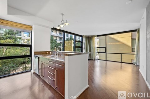 A modern kitchen with white cabinets and a wooden countertop.