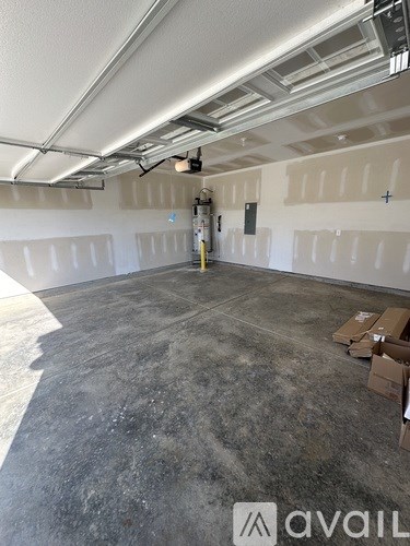 A large empty room with a grey floor and white walls.
