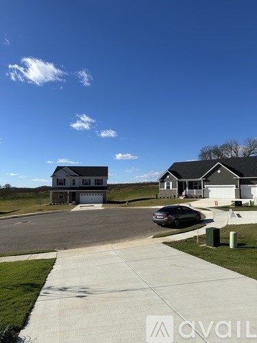 A house with a car parked in front of it.