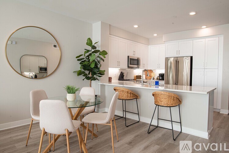 A modern kitchen with a bar area and a dining table set up.