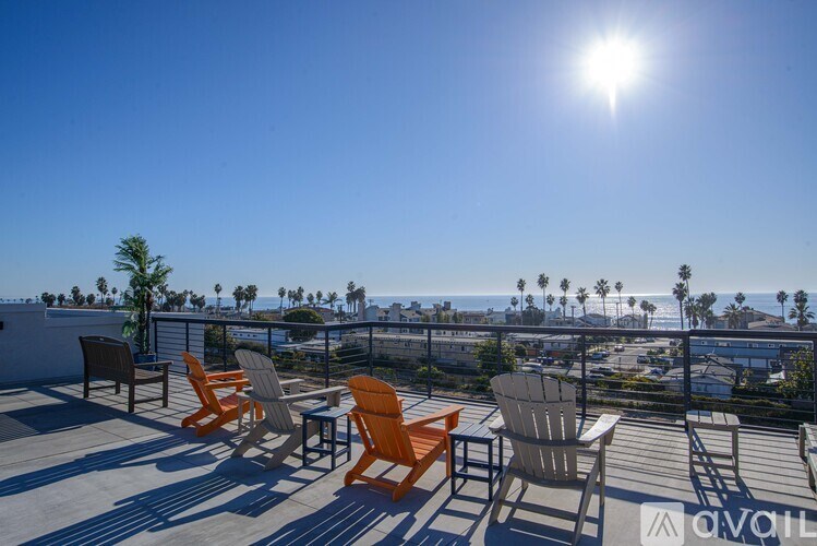 A sunny day on a patio with chairs and a table.