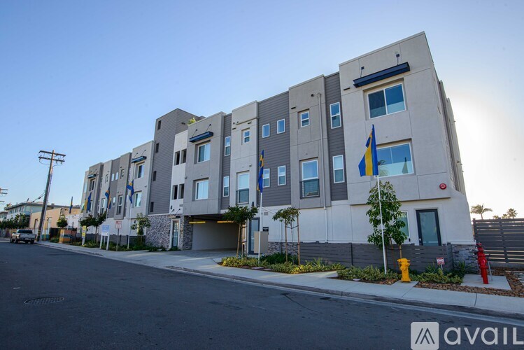 A modern apartment building with a flag on the front.