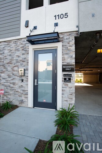 A stone building with a glass door and a sign that says "Resident Only".