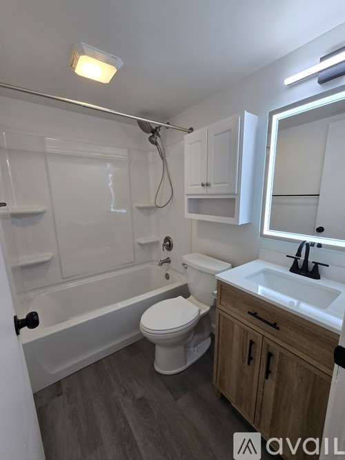 A bathroom with a white toilet, a white sink, and a white bathtub.