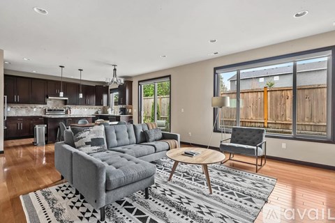 A modern living room with a grey sofa and a wooden coffee table.