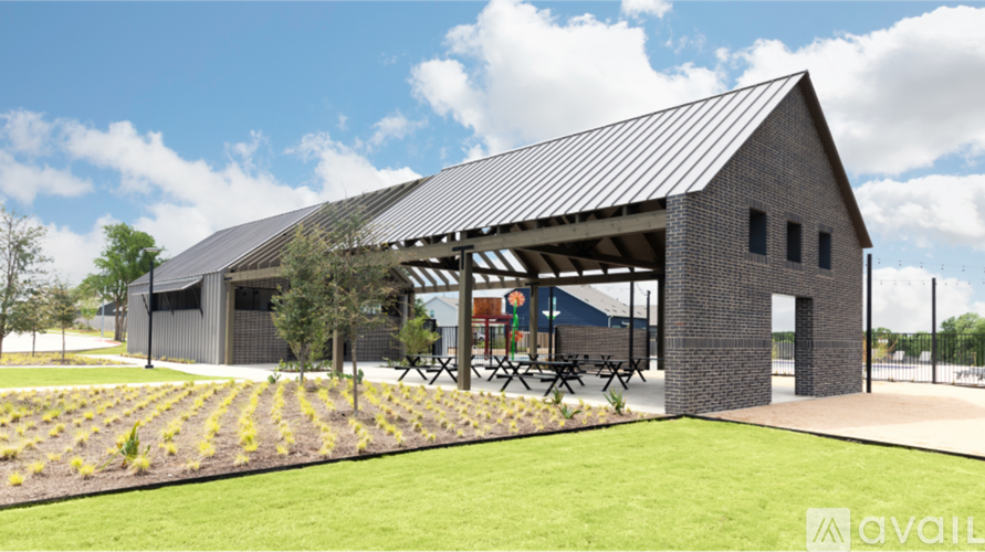 A modern building with a metal roof and a covered patio area.