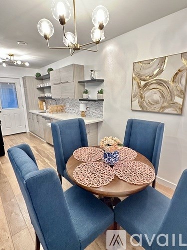 A dining area with a round table and chairs.