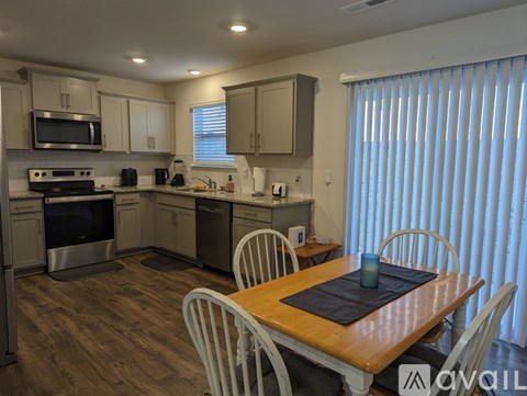 A kitchen with a dining table and chairs.