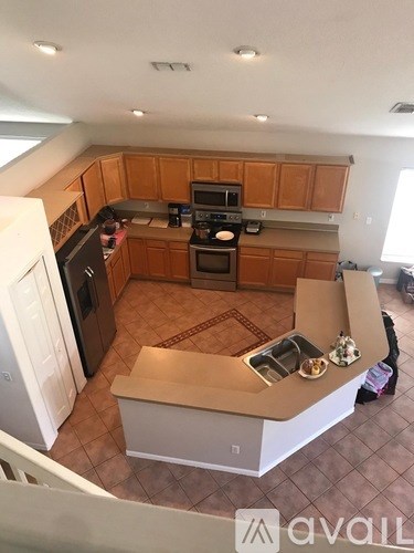 A kitchen with wooden cabinets and a white fridge.