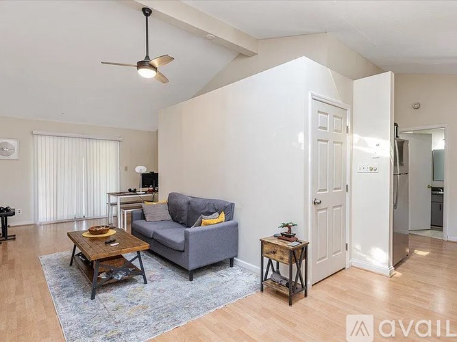 A living room with a grey couch and a coffee table.