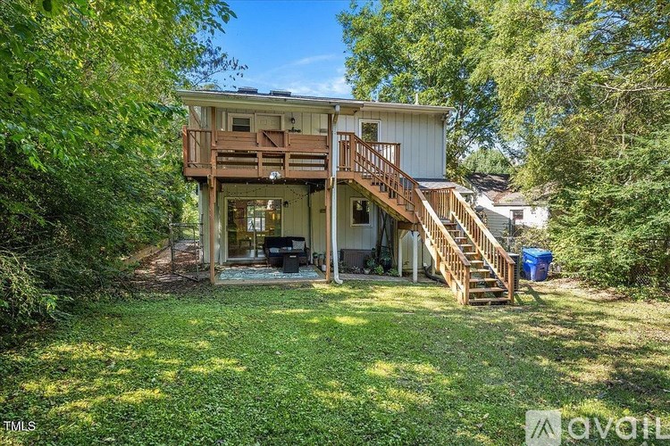 A house with a deck and a staircase leading to the upper floor.