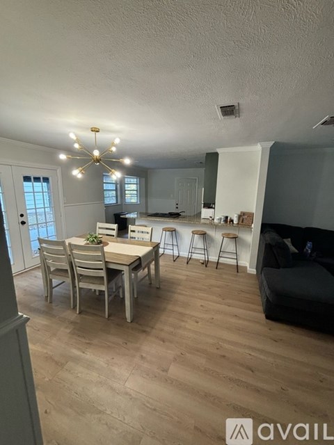 A living room with a dining table and chairs.