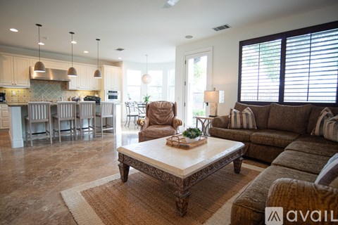 A living room with a brown sofa and a coffee table.