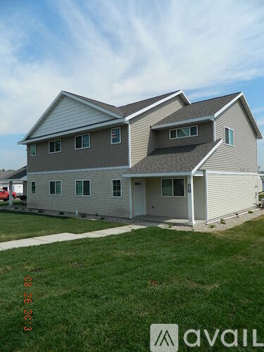 A two-story house with a grey and white exterior.