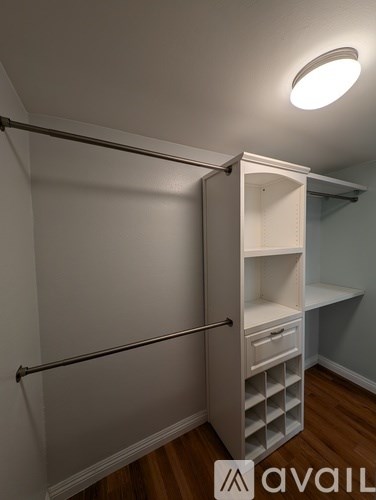 A white closet with a pull out shelf underneath it.