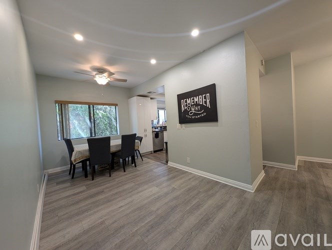A dining room with a table and chairs and a sign that says "Remember".