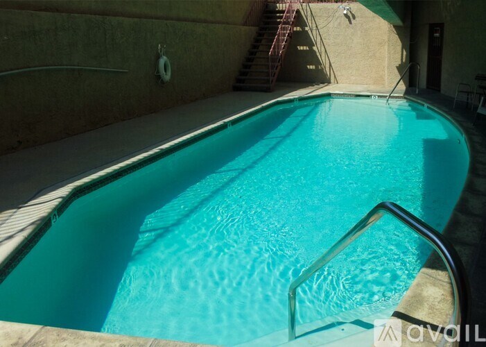 A small pool with a metal railing.