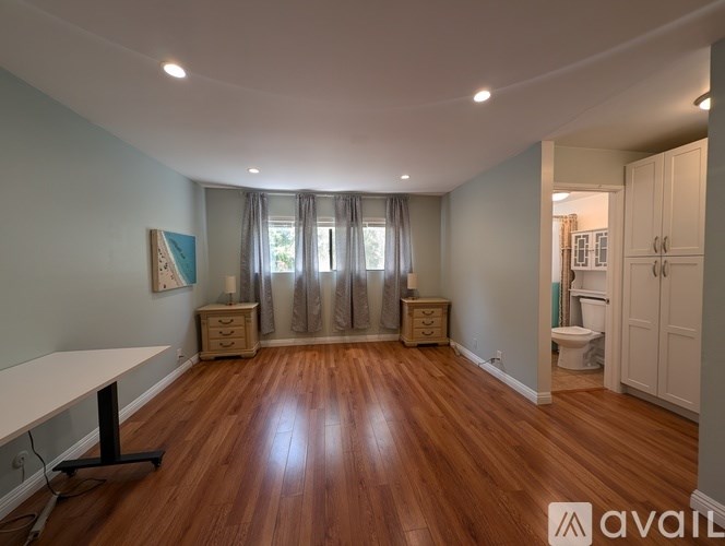 A room with wooden floors and a white table.