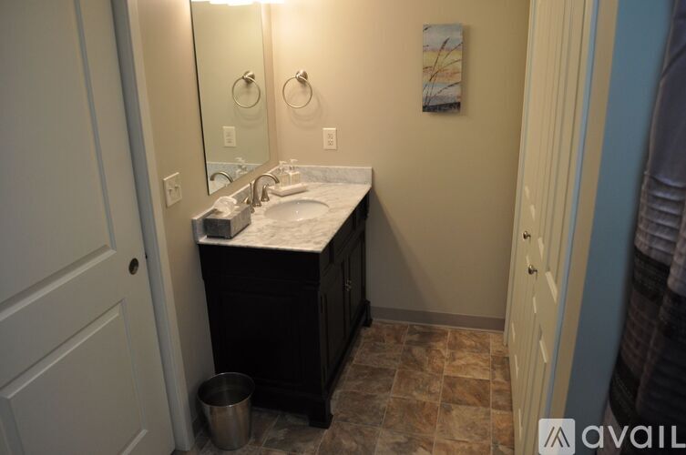 A bathroom with a sink and mirror.