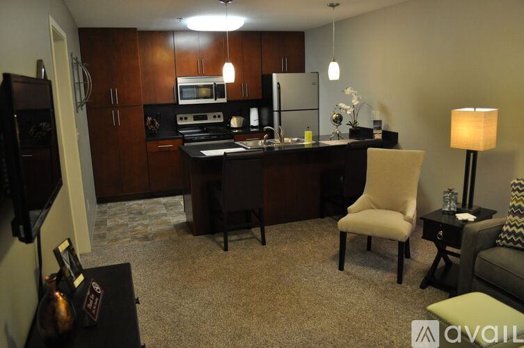 A kitchen with a table and chairs in the middle of the room.