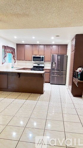 A kitchen with brown cabinets and a white countertop.