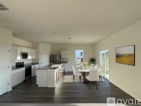 A modern kitchen with a dining table set for four.