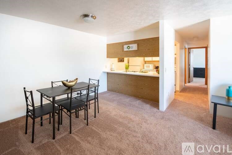 A dining area with a table and chairs in a room.