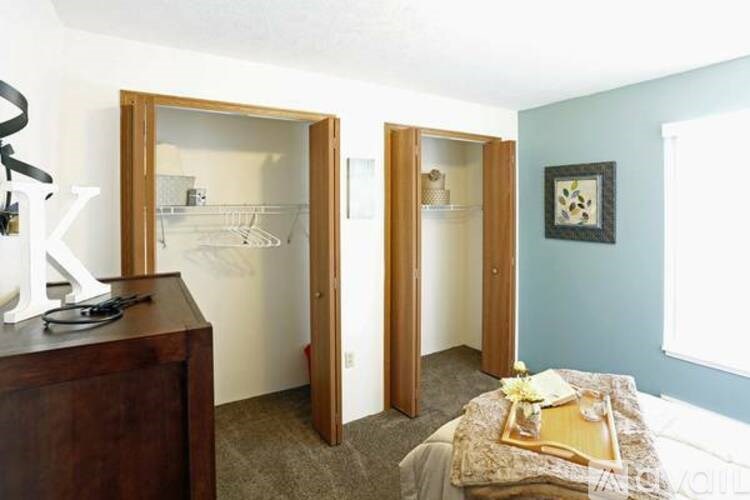 A bedroom with a bed, a dresser, and a mirror.