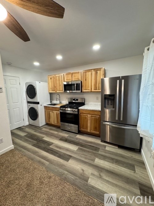 A kitchen with wooden cabinets and stainless steel appliances.