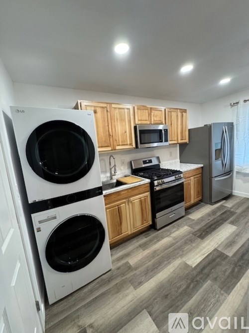 A kitchen with a white dishwasher and a white oven.