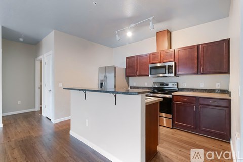 A kitchen with brown cabinets and a white counter.
