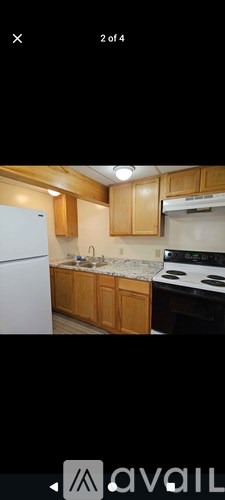 A kitchen with wooden cabinets and a white refrigerator.