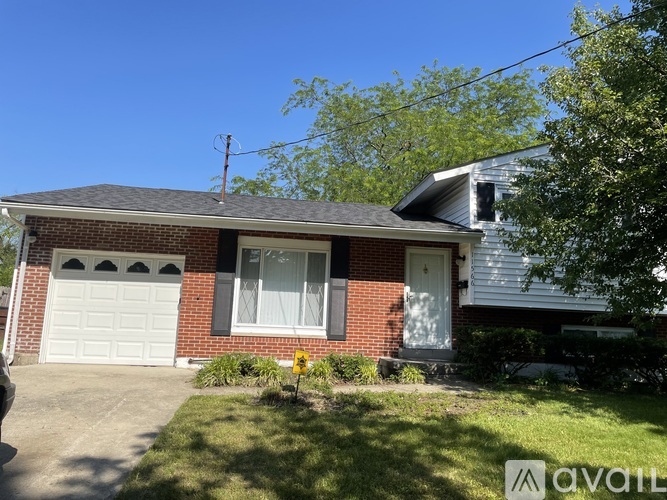 A house with a garage and a driveway in front.