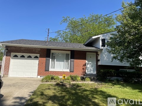 A house with a garage and a driveway in front.