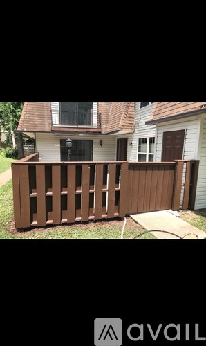 A wooden fence in front of a house.