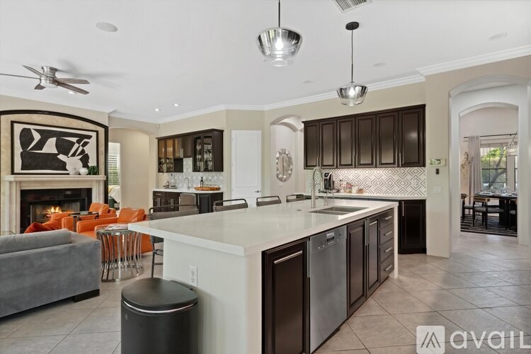 A modern kitchen with a large island and a fireplace.