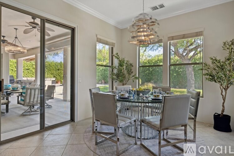 A dining room with a glass table and chairs.