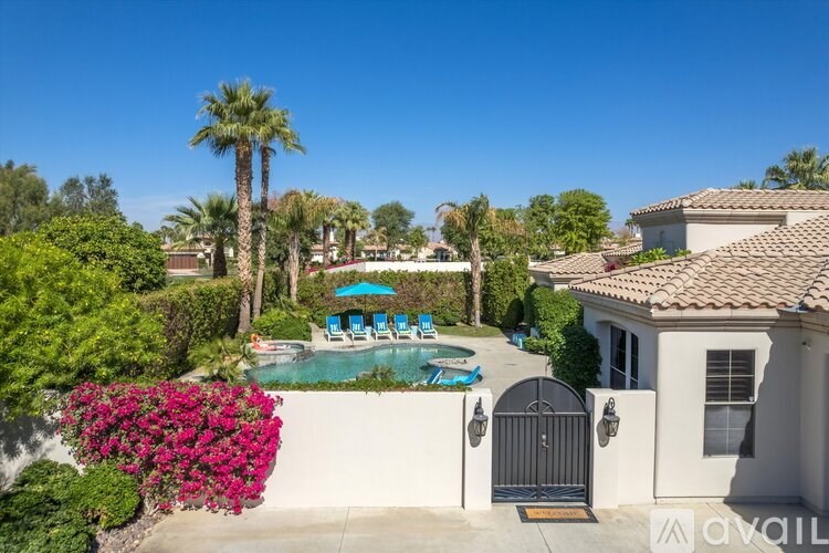 A house with a pool and a gate in front of it.