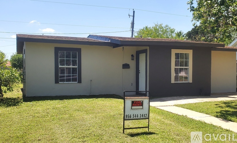 A house with a for sale sign in front of it.