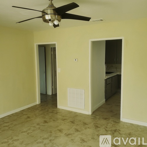 A room with a ceiling fan and a light fixture.