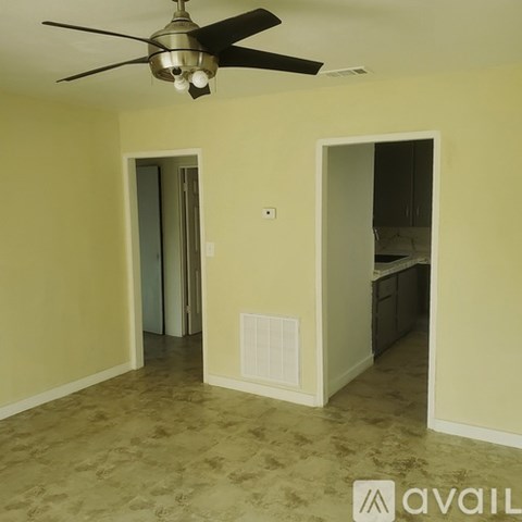 A room with a ceiling fan and a light fixture.