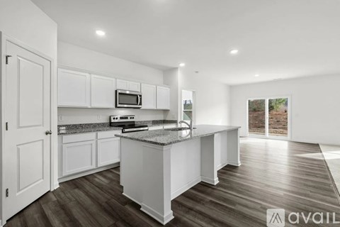 A modern kitchen with white cabinets and a central island.