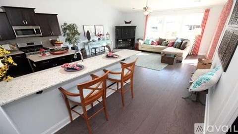 A kitchen with a dining table and chairs.