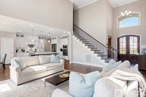 A living room with a white couch and a coffee table.