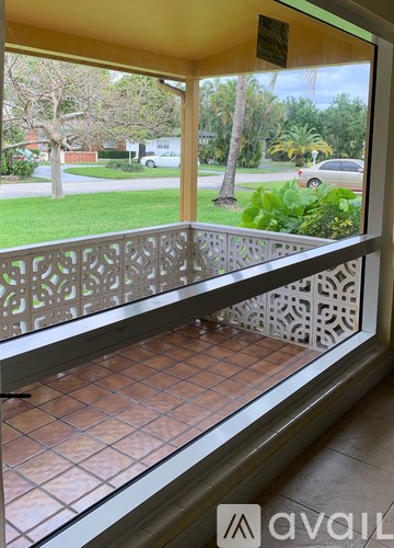 A balcony with a tiled floor and a metal railing.