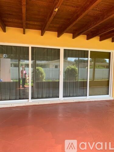 A room with a red floor and a wooden ceiling.